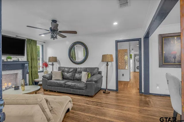 a living room with fireplace furniture and a flat screen tv