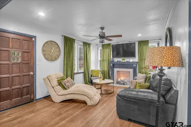 a living room with furniture a fireplace and a flat screen tv