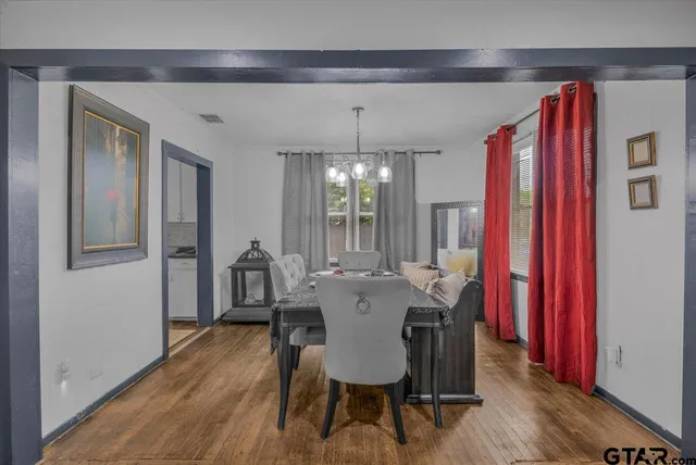 a view of a dining room with furniture and chandelier