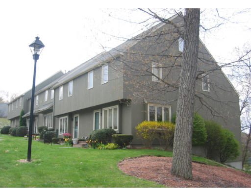 15-5 Deer Path, Unit 5 Maynard, MA 01754 - Photo 1 of 1 a view of a brick house with a big yard plants and large trees