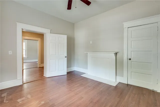 an empty room with wooden floor and closet