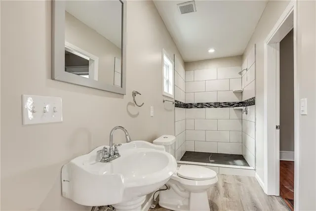 a bathroom with a sink toilet and shower
