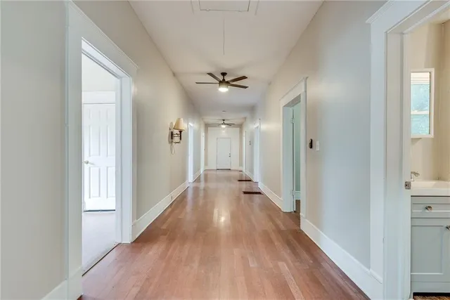 a view of a hallway with wooden floor