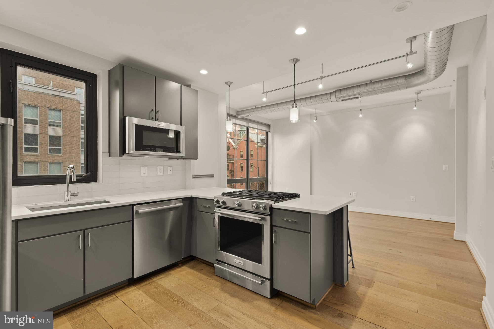 301 H Street Northeast, Unit 305 Washington, DC 20002 - Photo 11 of 25 a kitchen with stainless steel appliances a sink stove and refrigerator