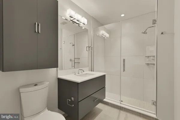 a bathroom with a toilet sink and shower