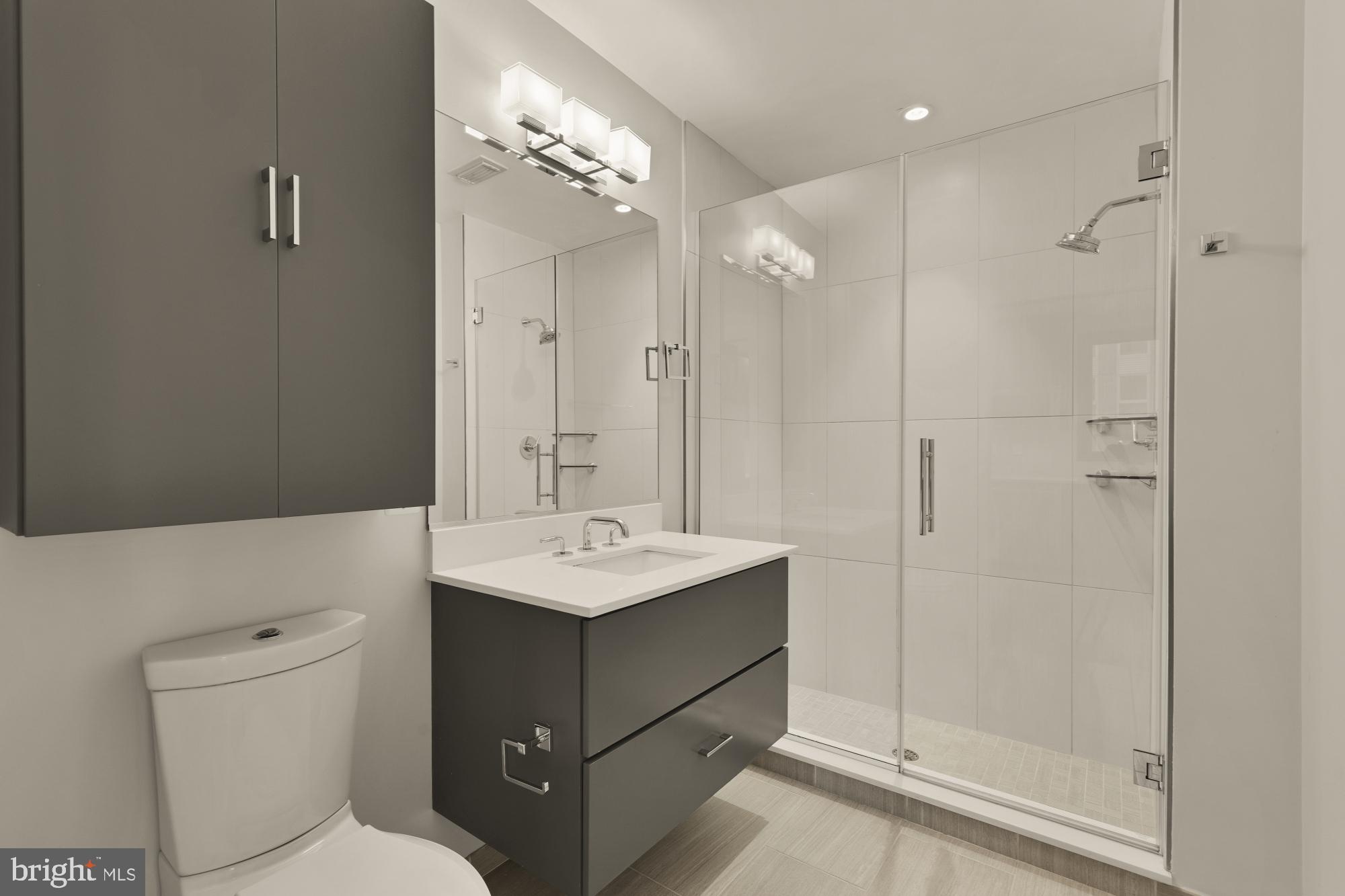301 H Street Northeast, Unit 305 Washington, DC 20002 - Photo 12 of 25 a bathroom with a toilet sink and shower