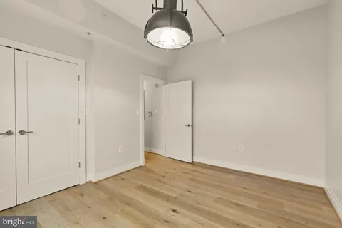 a view of empty room with wooden floor