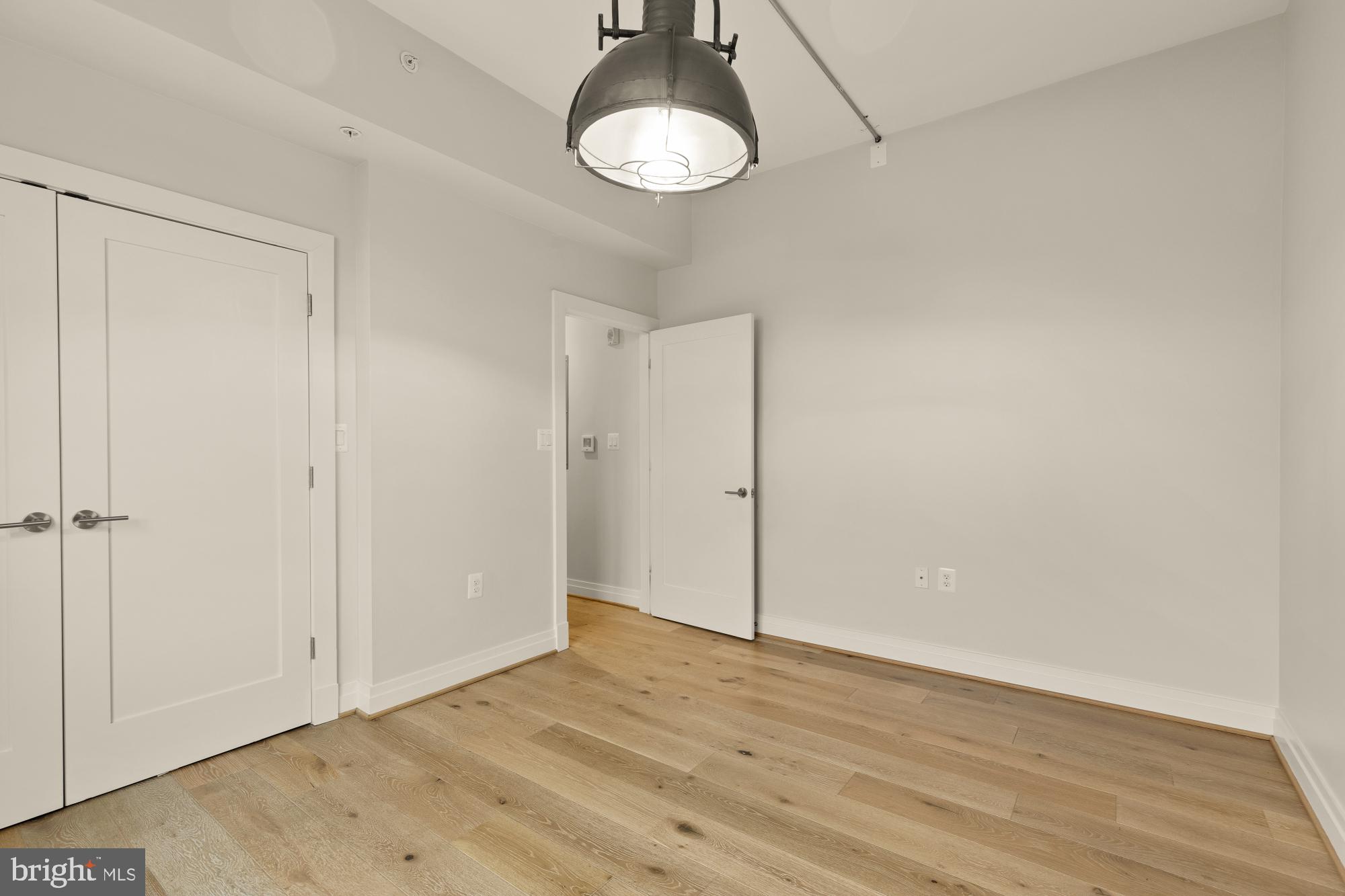 301 H Street Northeast, Unit 305 Washington, DC 20002 - Photo 20 of 25 a view of empty room with wooden floor