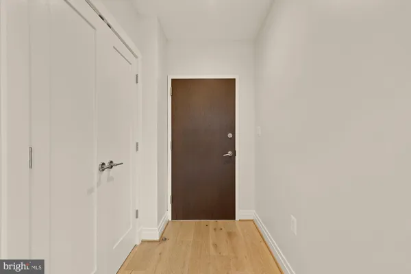 a view of a hallway with wooden floor