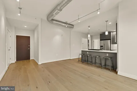 a view of a kitchen with a sink and a refrigerator