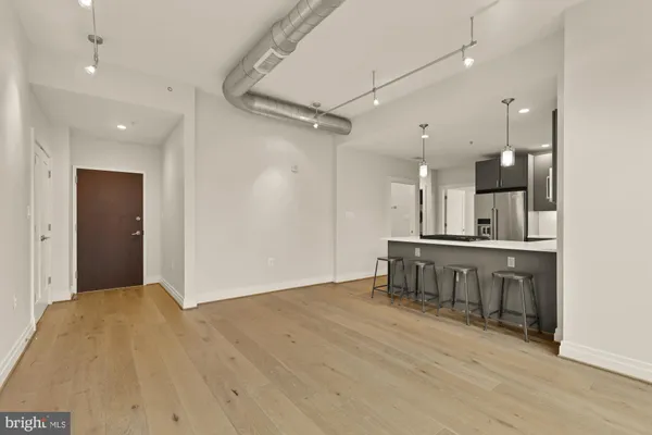 a view of a kitchen with a sink and a refrigerator