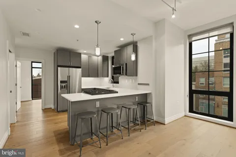 a large kitchen with a table and chairs