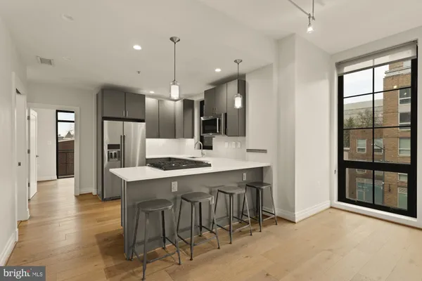 a large kitchen with a table and chairs