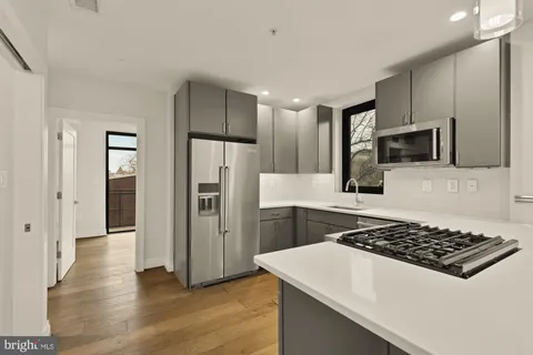a kitchen with a sink a stove and refrigerator