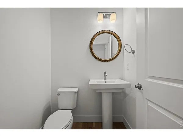 a bathroom with a toilet a sink and a mirror