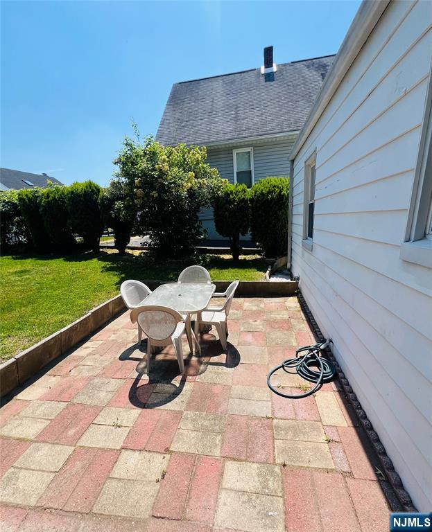 18 Pershing Street Garfield, NJ 07026 - Photo 3 of 16 a view of a patio with table and chairs under an umbrella