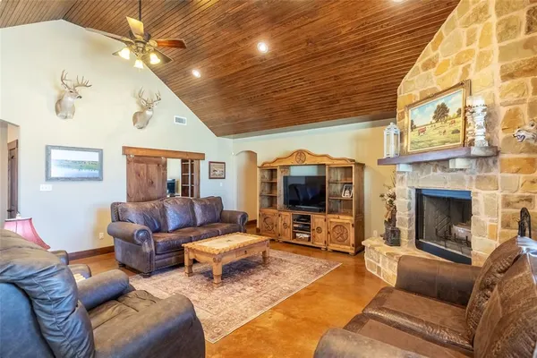 a living room with furniture fireplace and flat screen tv