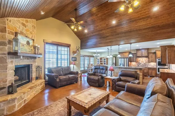a living room with furniture a flat screen tv and a fireplace