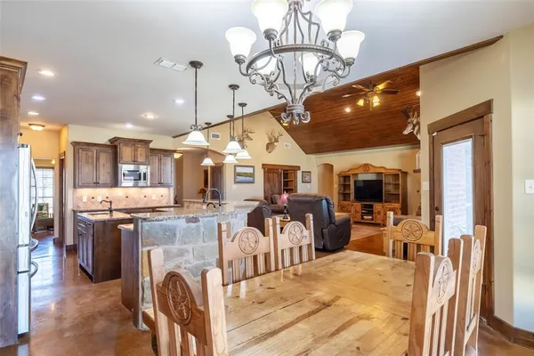 a living room with furniture a fireplace and a chandelier