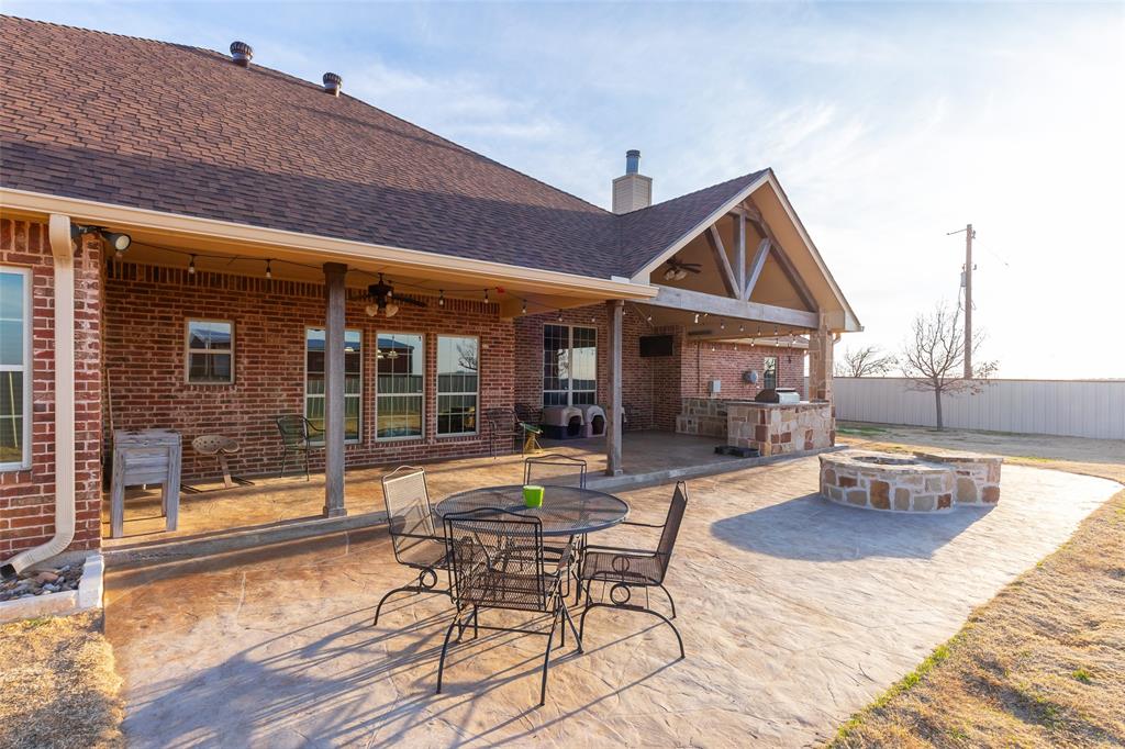 14600 Interstate 20 Roscoe, TX 79545 - Photo 32 of 40 Custom Stamped Concrete Patio & Stone Propane Fueled Fire-pit With Faux Logs