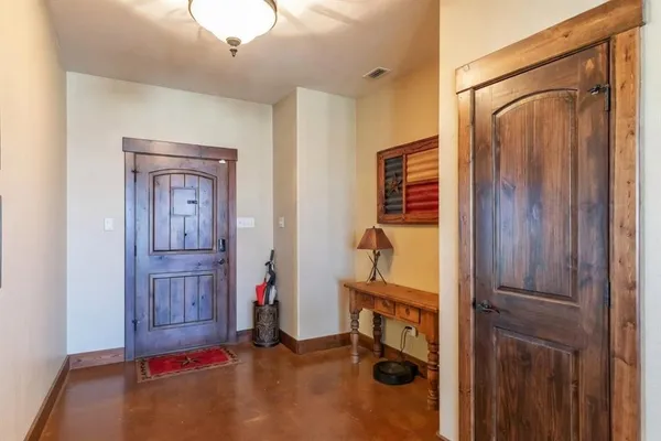 a view of a hallway with closet and cabinet