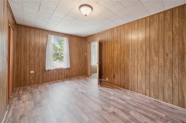 a view of an empty room with a chandelier fan