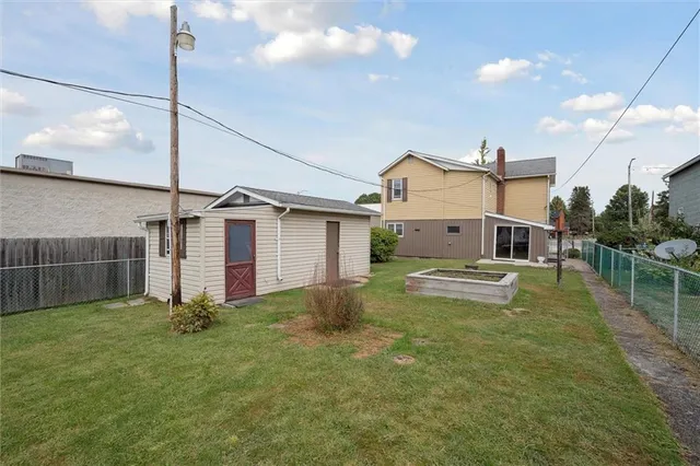 a view of a house with a yard and a garage