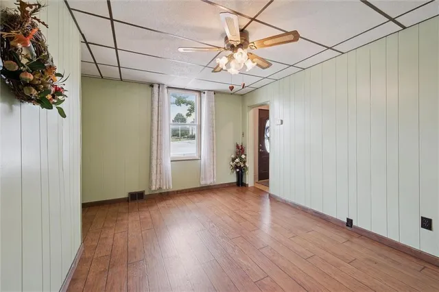 a kitchen with stainless steel appliances granite countertop a sink dishwasher stove and refrigerator with wooden cabinets