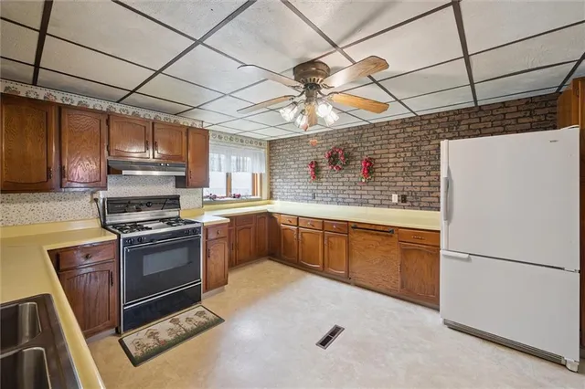 a kitchen with stainless steel appliances granite countertop a sink and cabinets