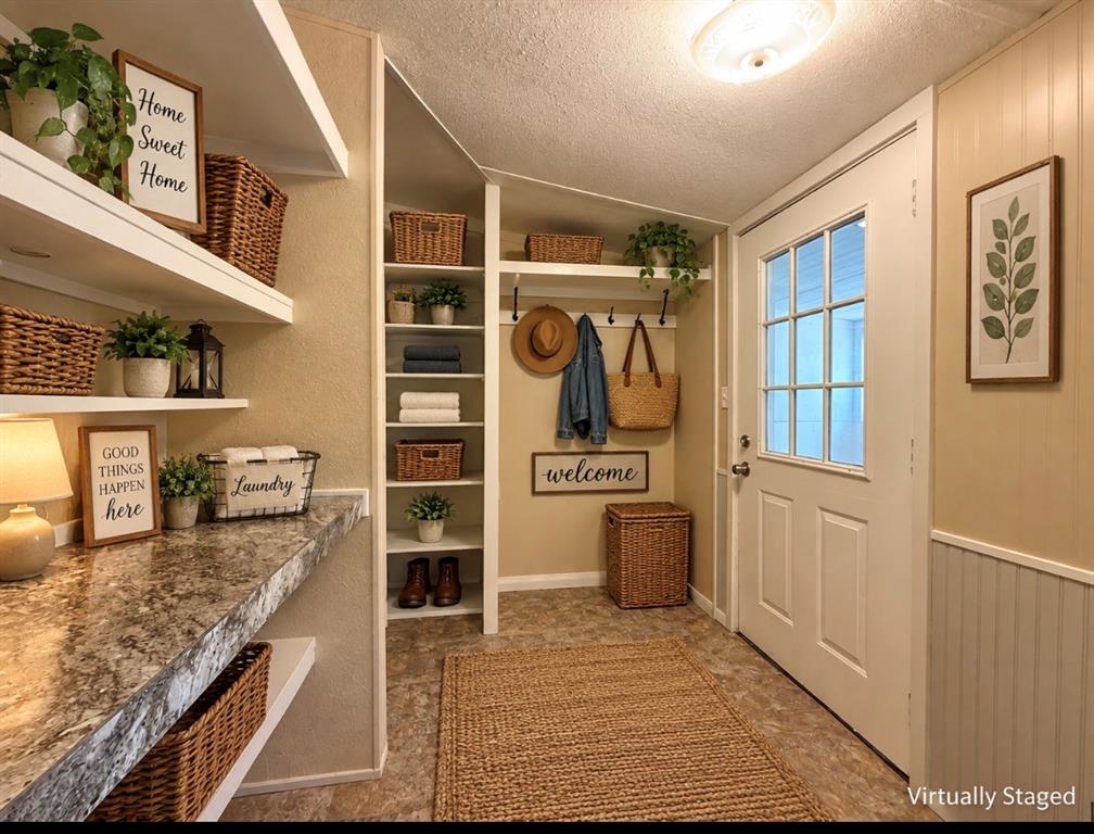 4676 Old Dallas Road Elm Mott, TX 76640 - Photo 8 of 21 Built-in shelving, white floating shelves, light-toned wall paneling, a multi-pane door, and a patterned countertop surface