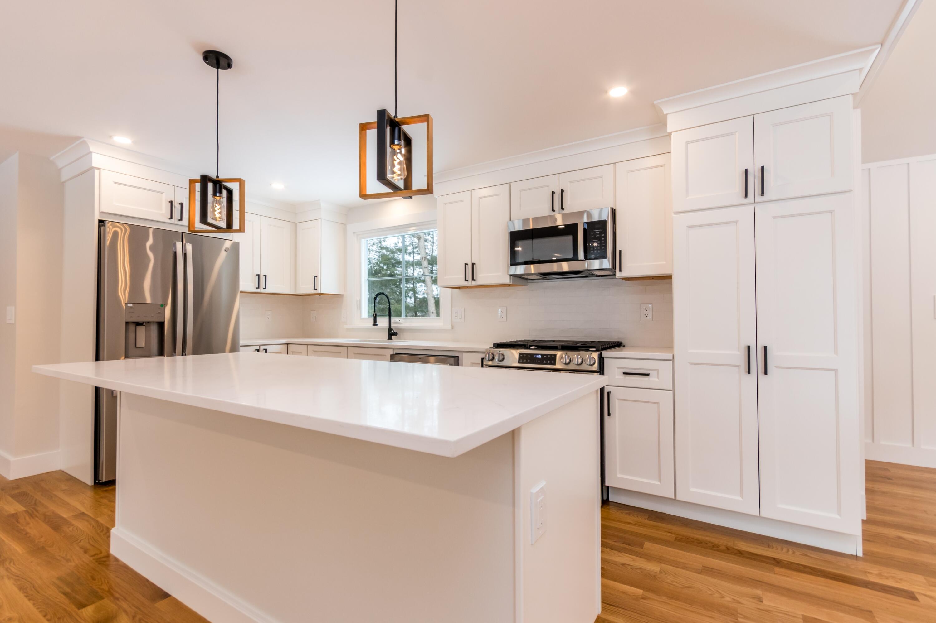 15 Jessica Way Waquoit, MA 02536 - Photo 6 of 41 White kitchen with stainless appliances