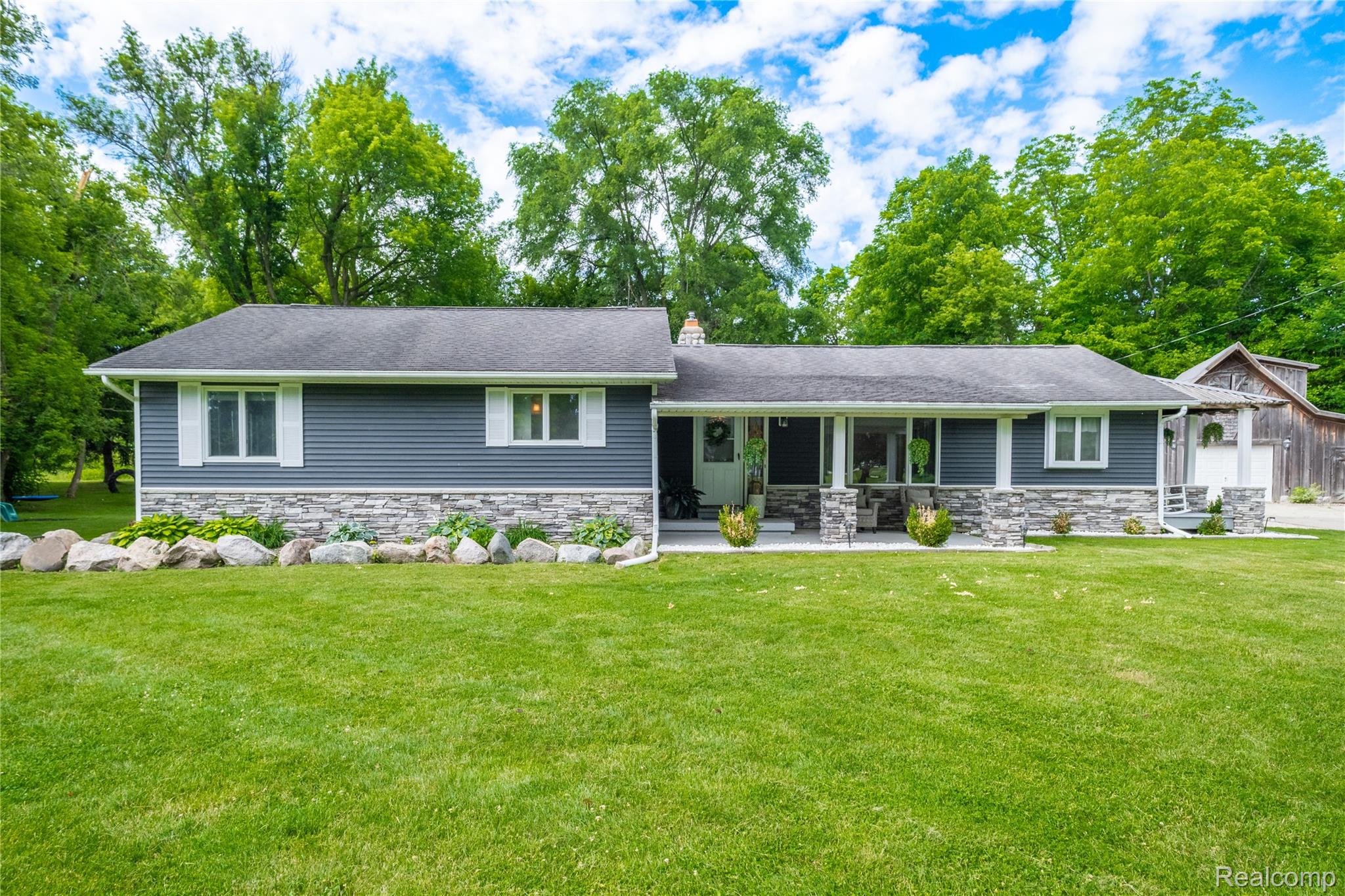 4418 North Gale Road Davison, MI 48423 - Photo 6 of 46 Ranch-style exterior featuring gray horizontal siding and a stone facade