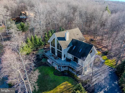 an aerial view of a house with a yard and garden