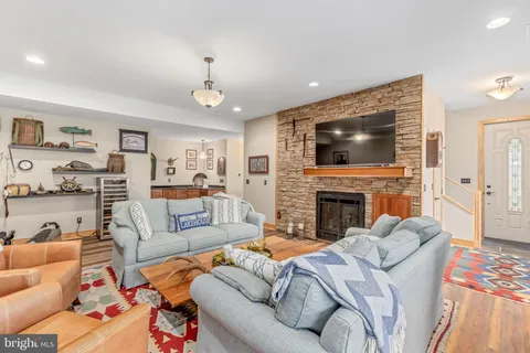 a kitchen with stainless steel appliances granite countertop a stove and a wooden floor