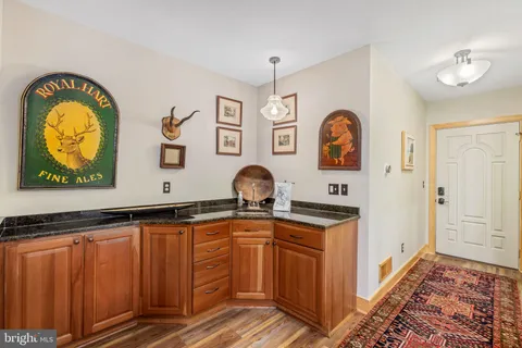 a bathroom with a sink mirror and a toilet