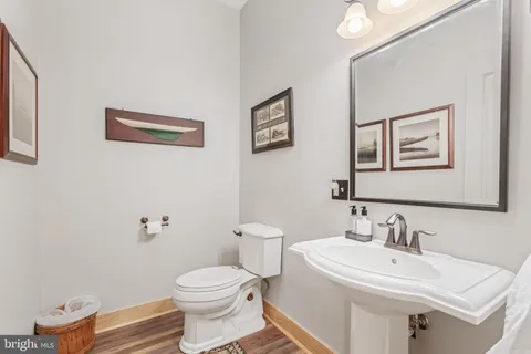 a bedroom with a bed a flat screen tv and a chandelier