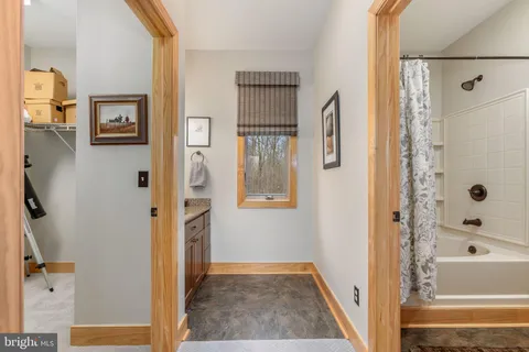 a bedroom with bed and wooden floor