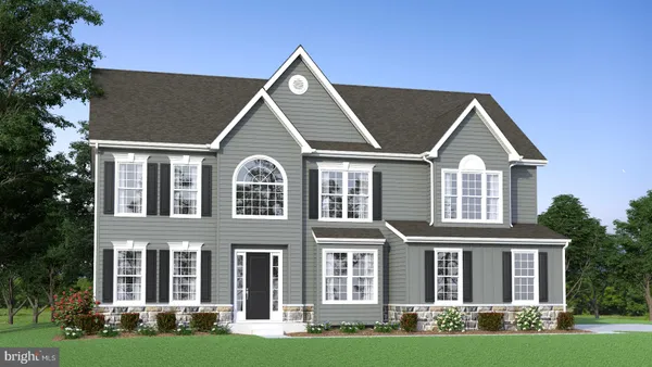 front view of a brick house with a yard