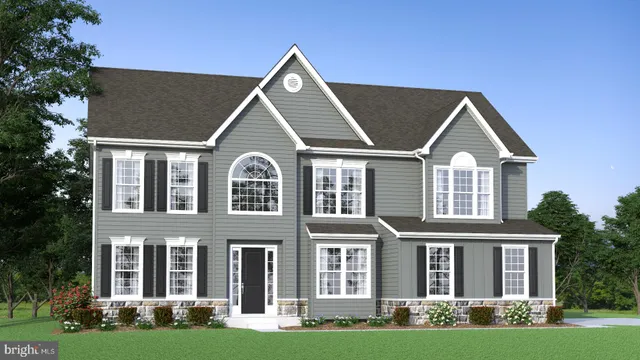 front view of a brick house with a yard