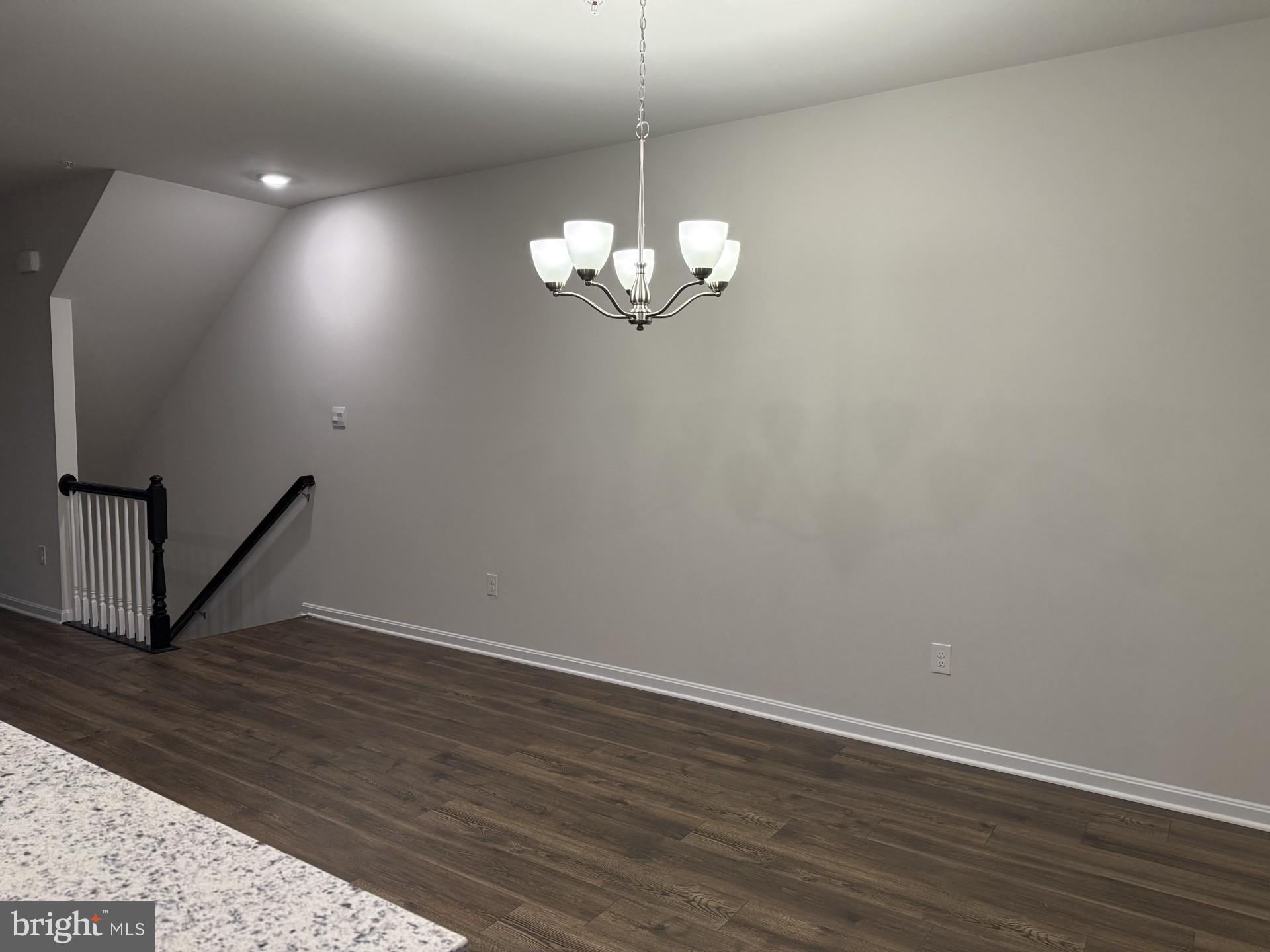 742 Compass Way Frederick, MD 21701 - Photo 12 of 30 a view of a room with wooden floor and chandelier