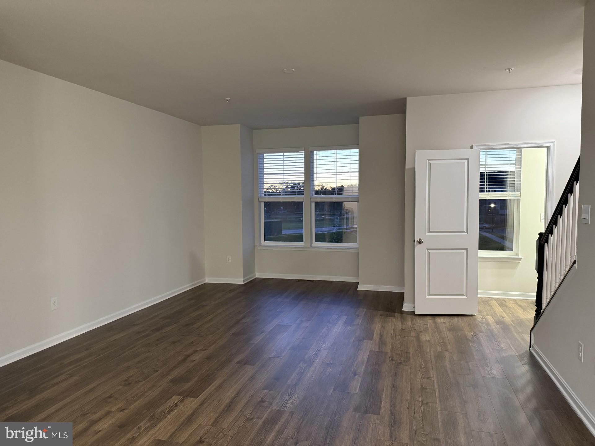 742 Compass Way Frederick, MD 21701 - Photo 13 of 30 an empty room with wooden floor and windows