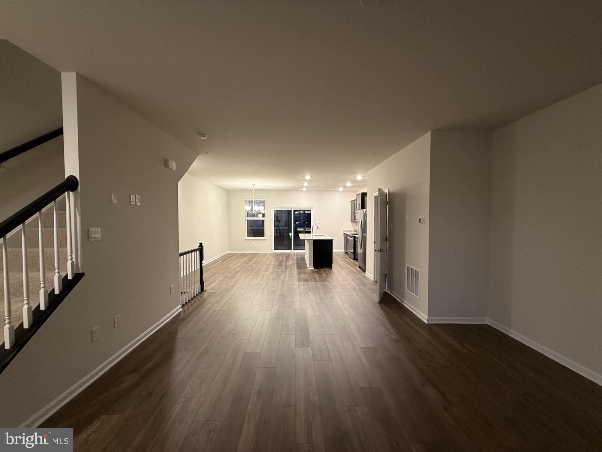 742 Compass Way Frederick, MD 21701 - Photo 14 of 30 a view of a big room with wooden floor and windows