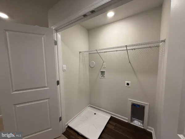 a view of staircase with railing and white walls