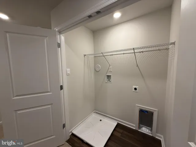 a view of staircase with railing and white walls