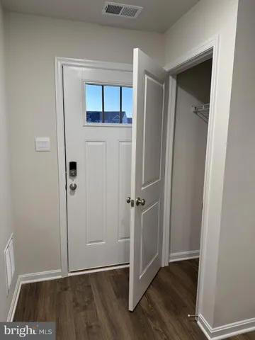 a view of front door with wooden floor