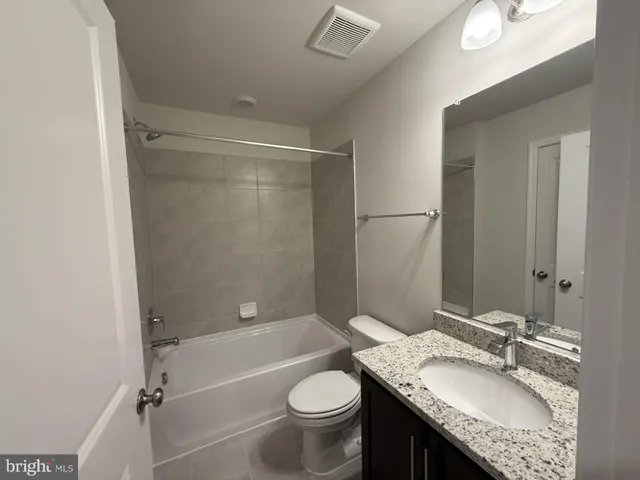 a bathroom with a shower and a toilet