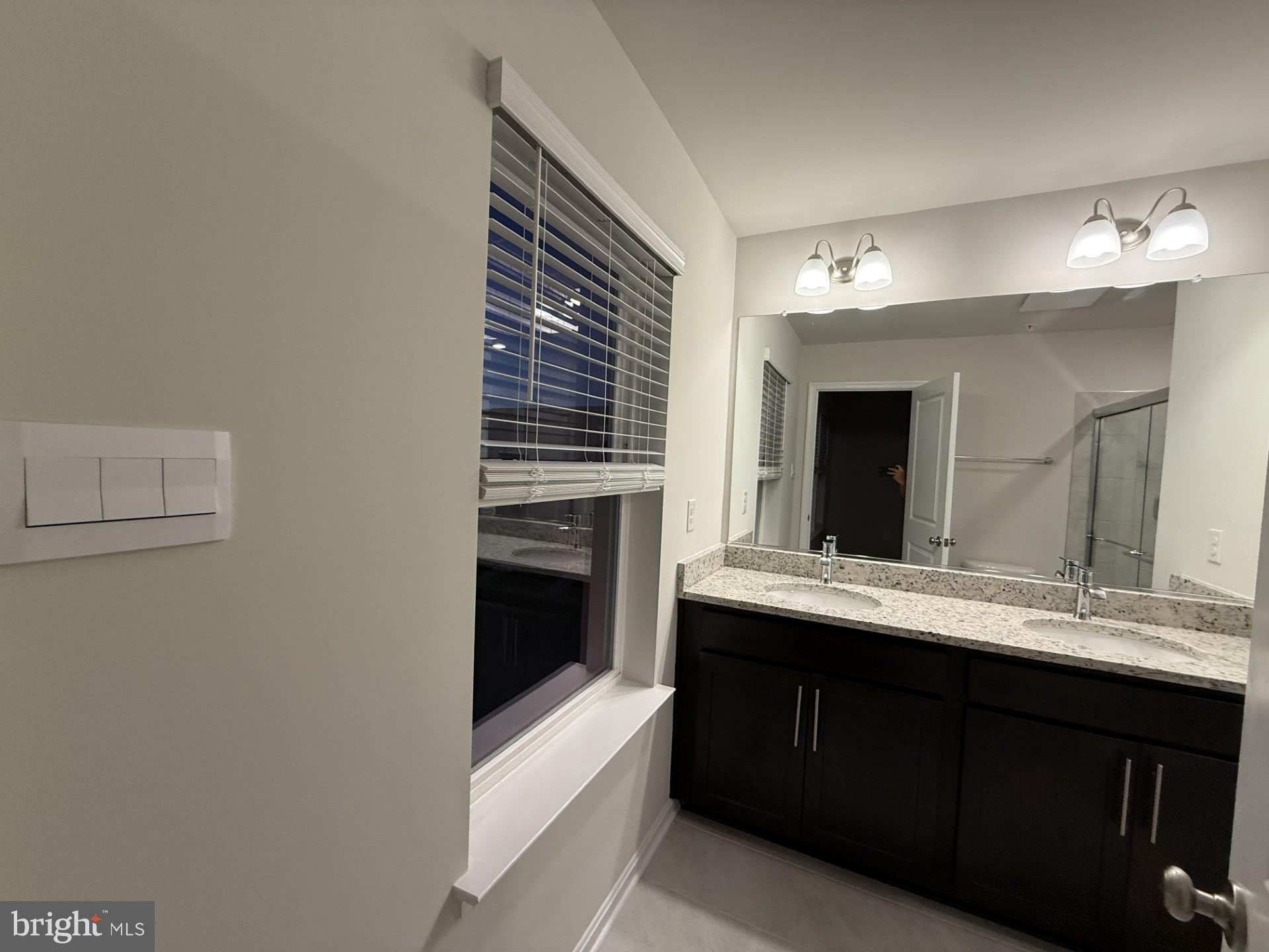 742 Compass Way Frederick, MD 21701 - Photo 24 of 30 a kitchen with a sink and a mirror