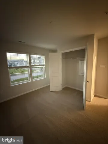 a large kitchen with stainless steel appliances a large counter top a refrigerator and a stove