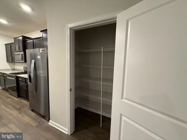 a kitchen with stainless steel appliances granite countertop sink stove refrigerator and cabinets