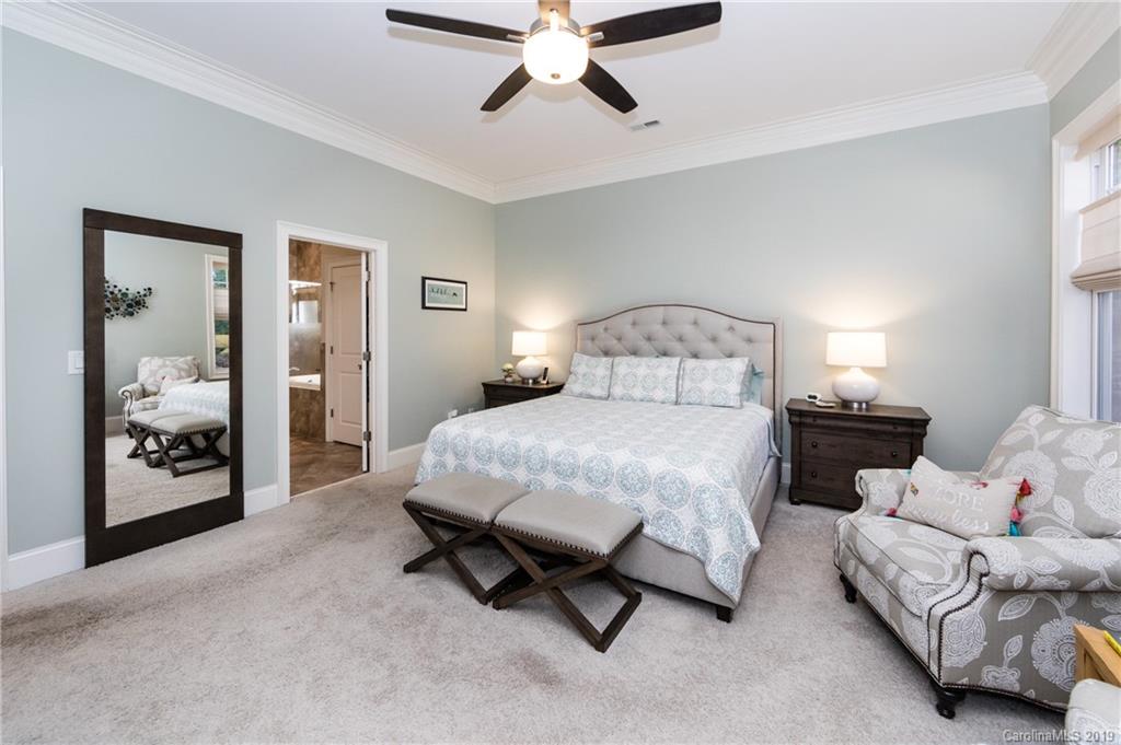 16905 Red Cow Road Charlotte, NC 28277 - Photo 22 of 47 a spacious bedroom with a bed and ceiling fan